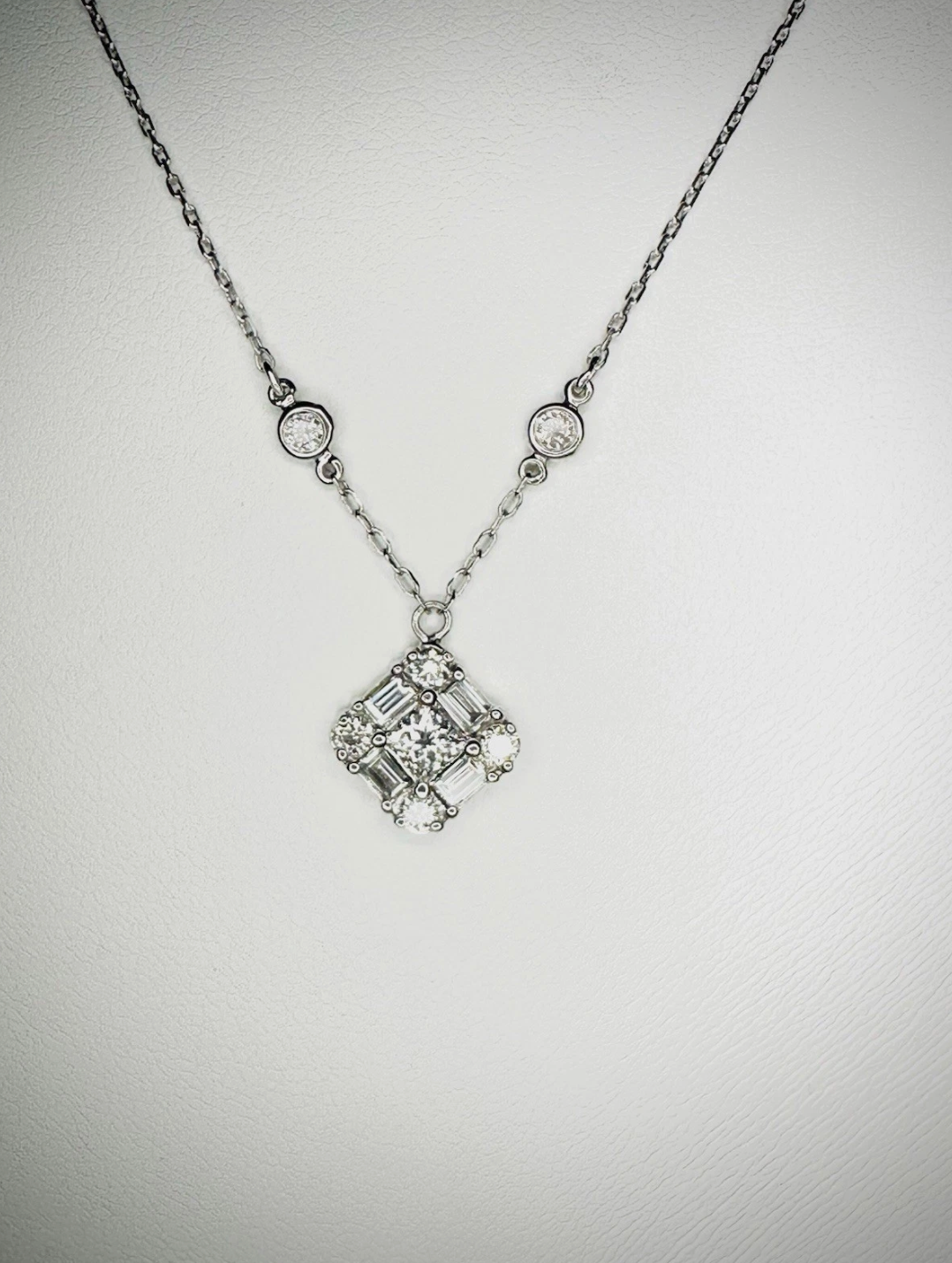 Emerald Cut Diamonds Seated In Pendant.