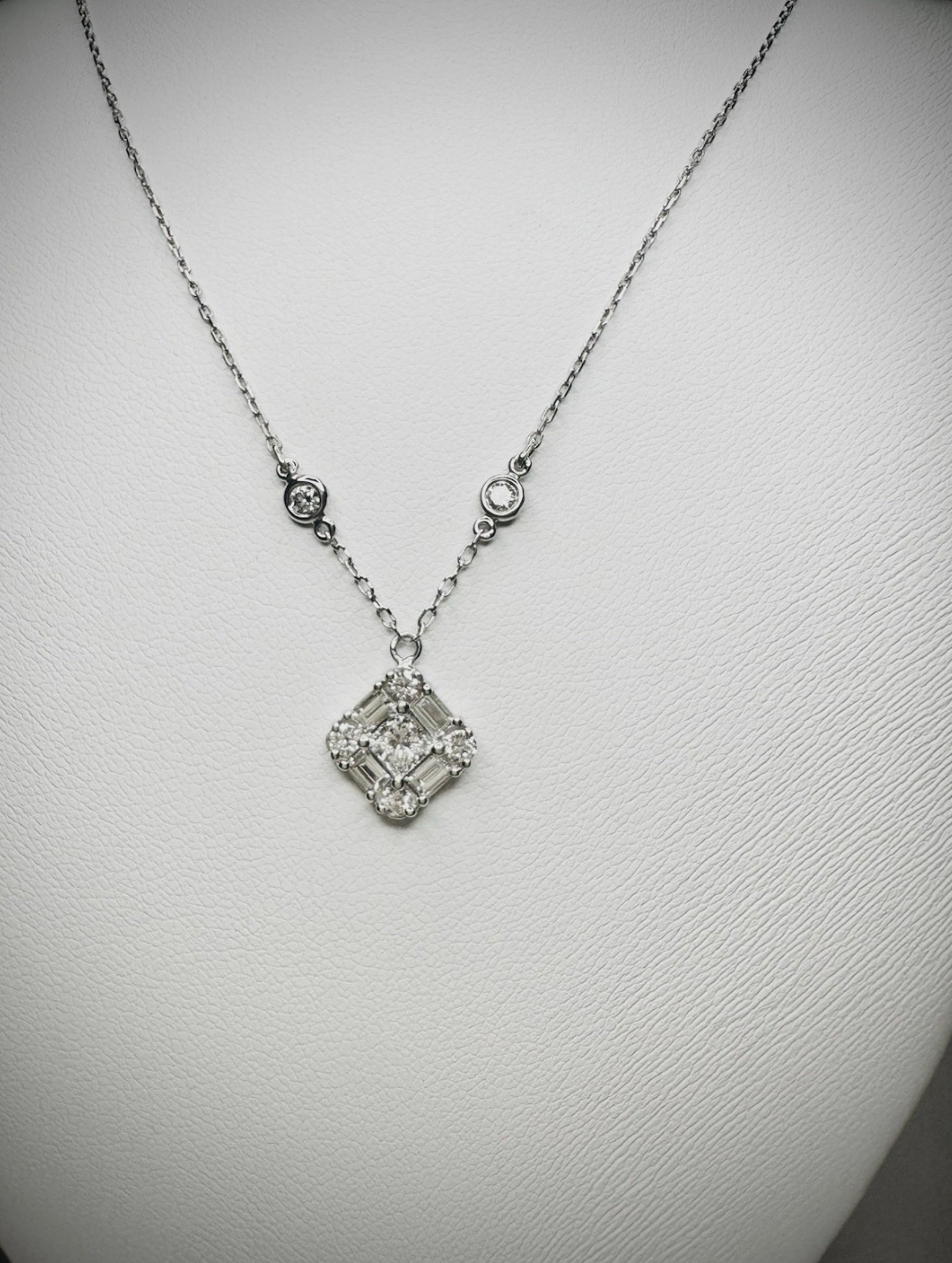 Emerald Cut Diamonds Seated In Pendant.