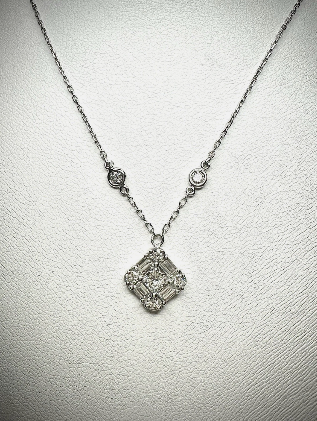 Emerald Cut Diamonds Seated In Pendant.