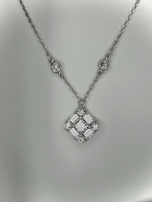 Emerald Cut Diamonds Seated In Pendant.